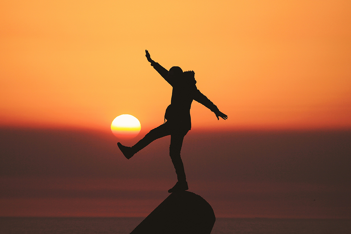 Person balancing on rock
