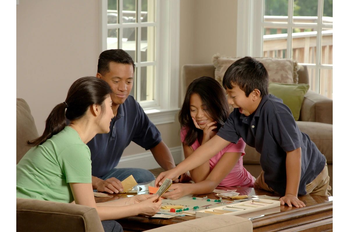 Image of family playing board game