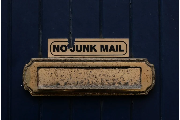 Image of a blue wall with a mailbox attached and the words "no junk mail" above