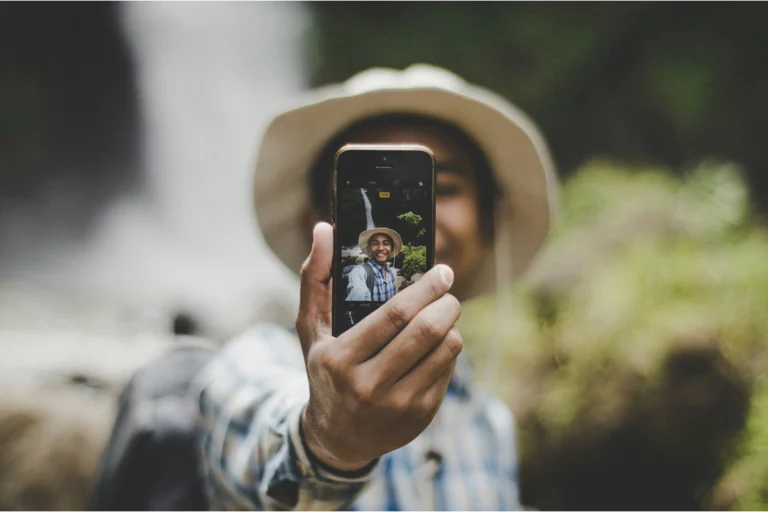 Image of person holding their phone up to take a selfie