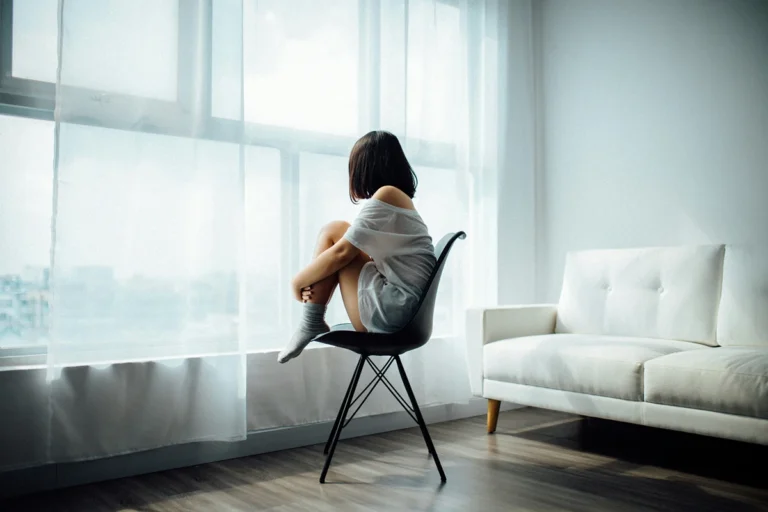 image of a person sitting on a chair looking at a window