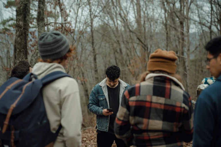 Image of person on their phone while outside with friends
