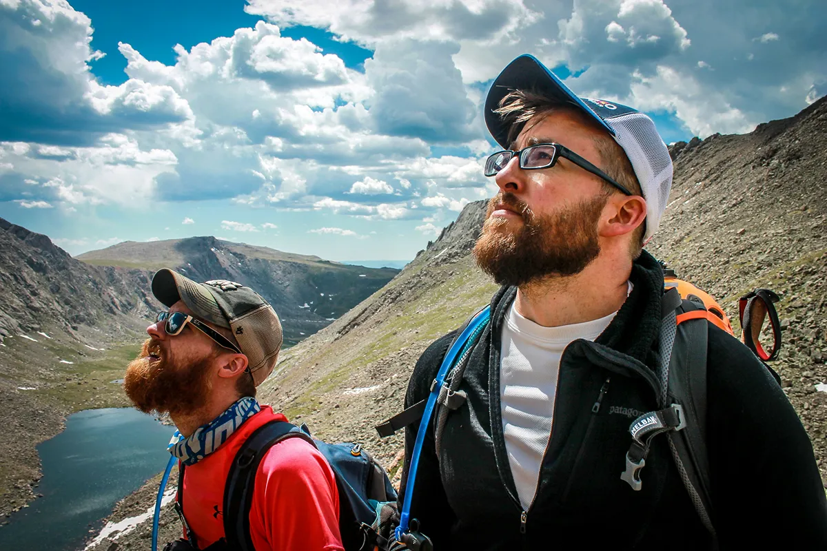 Image of two people hiking looking up at the hike ahead of them