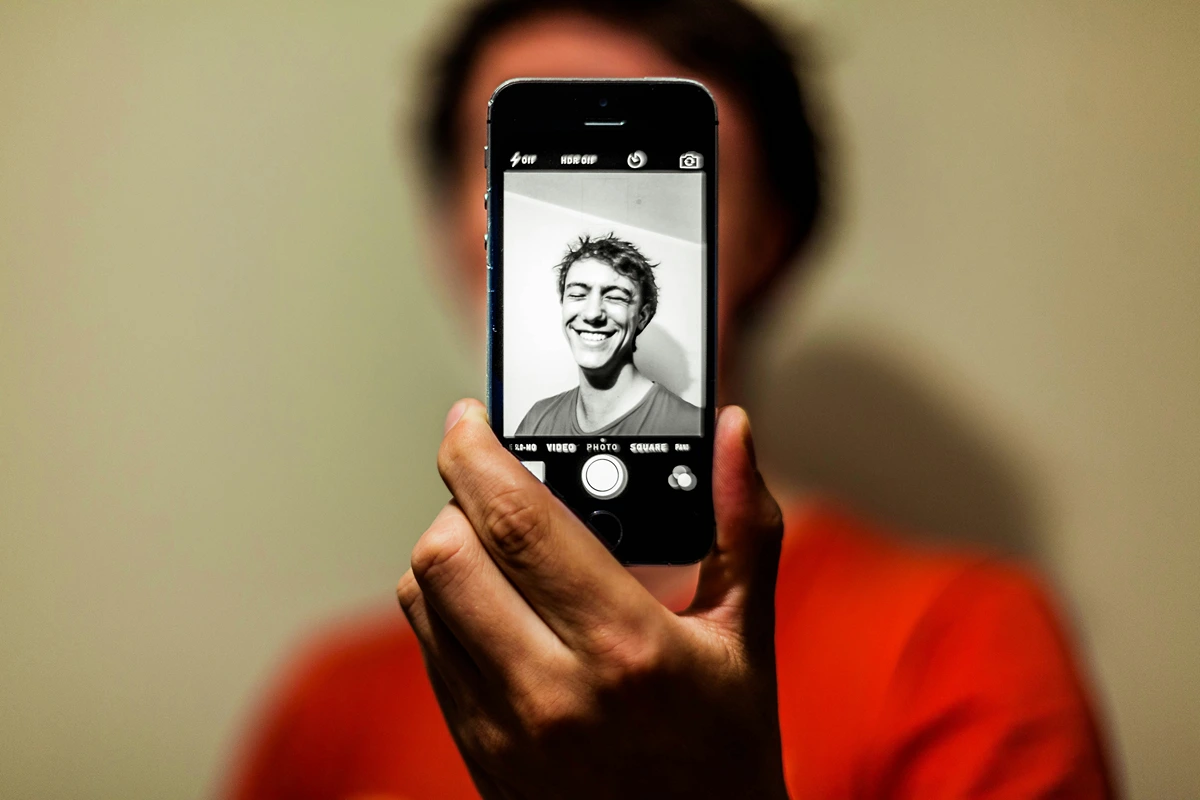 Image of person taking a selfie with their cell phone