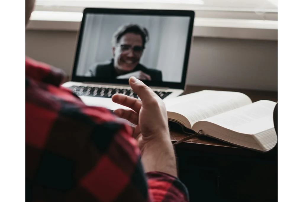 Image of person in front of computer on video call