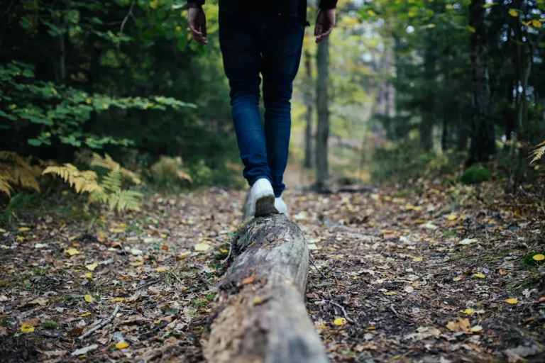 Image of person balancing on a log