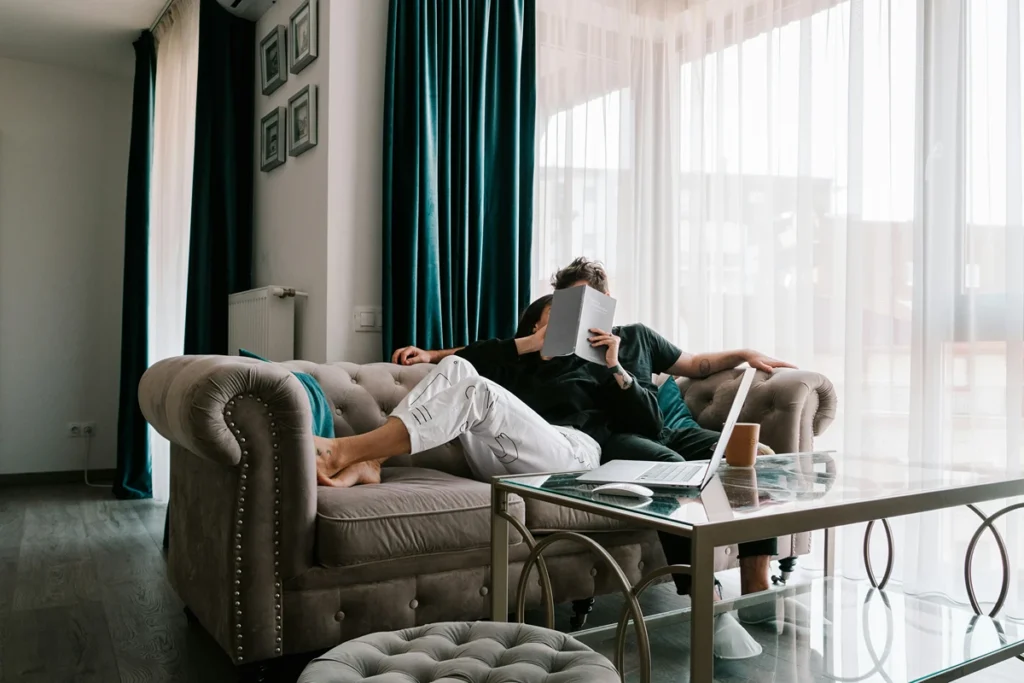 Image of a couple on a couch reading a book together
