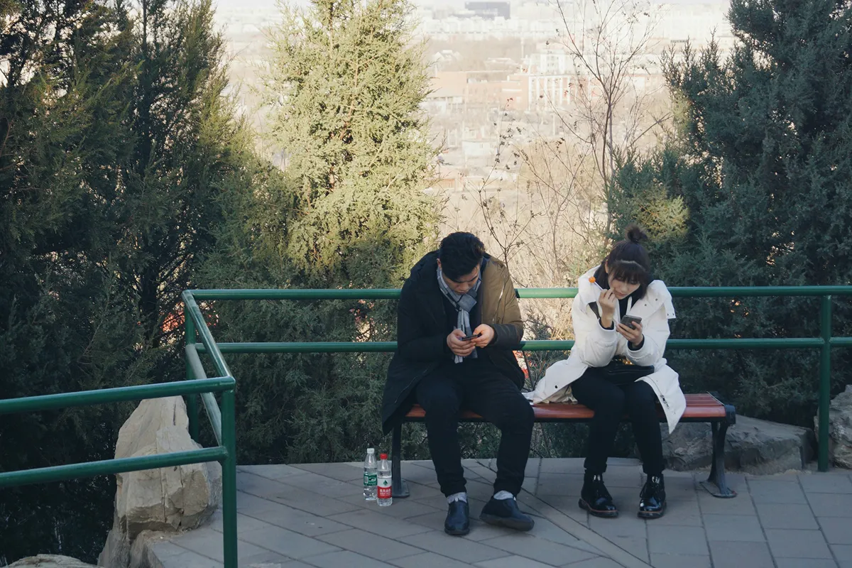 Image of a couple both on their phones