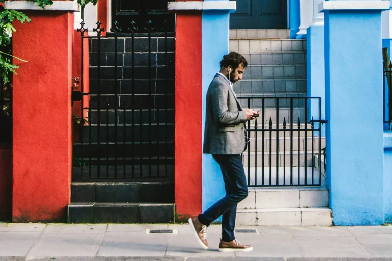 Image of person walking while on their phone