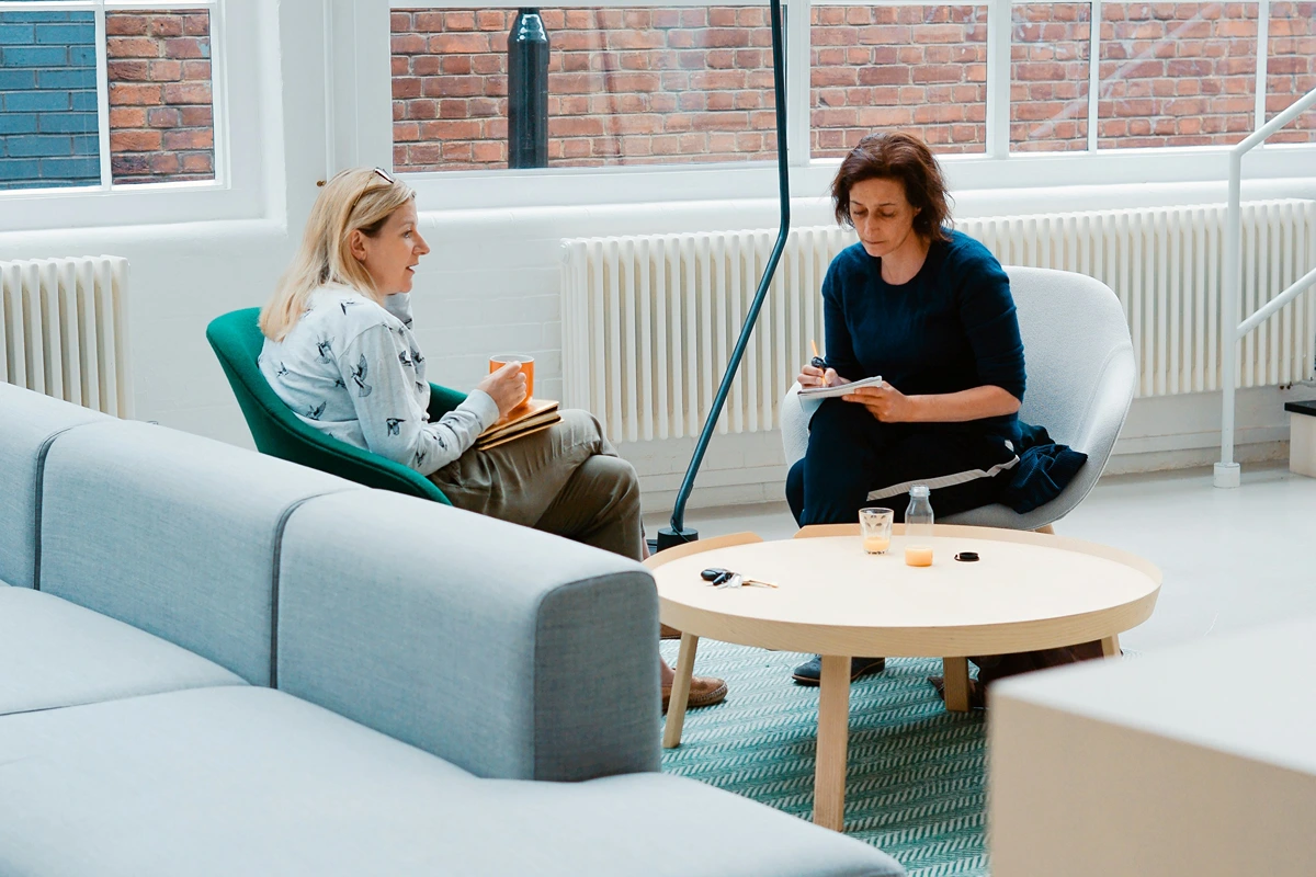 Image of a coach and client sitting together
