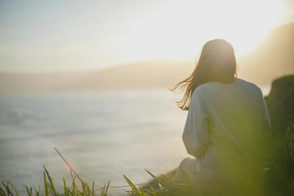 Woman in front of lake breathing