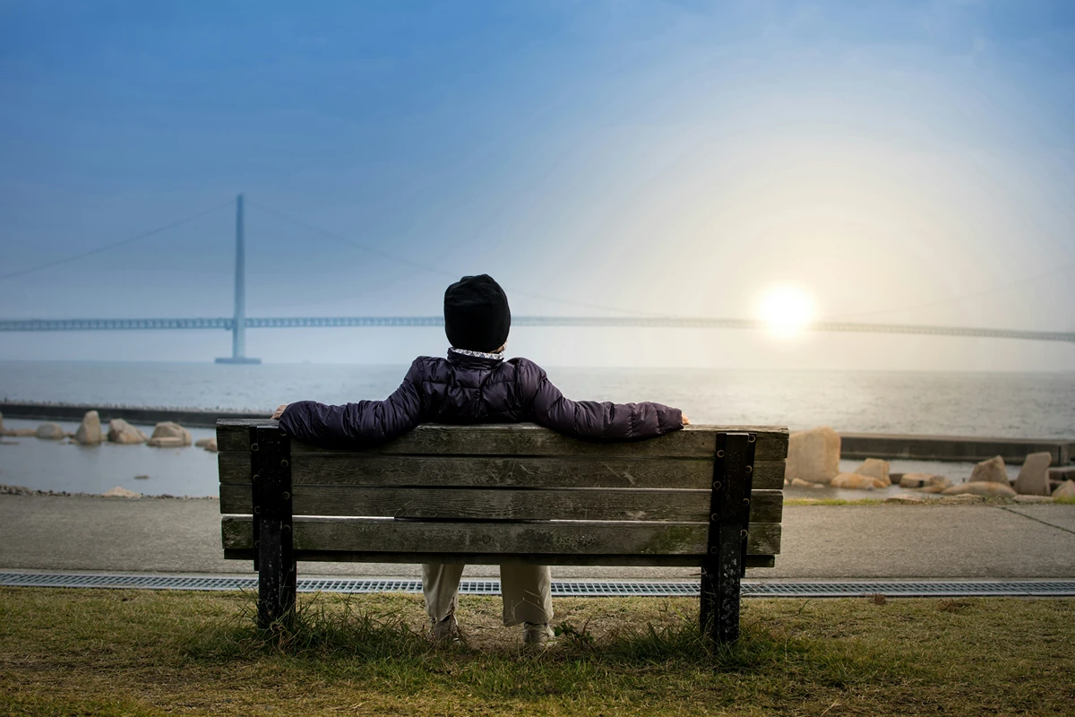 Person resting on a bench outdoors