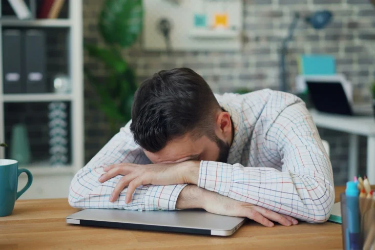 Person with their head on their laptop brain overwhelmed