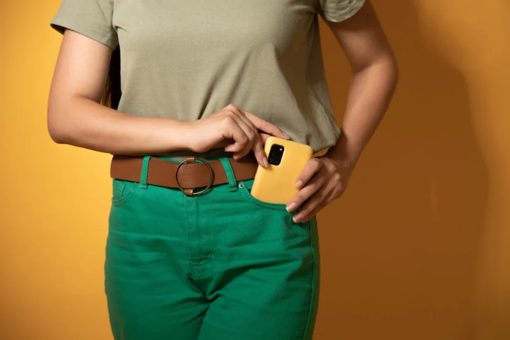 A woman putting her phone away in her pocket