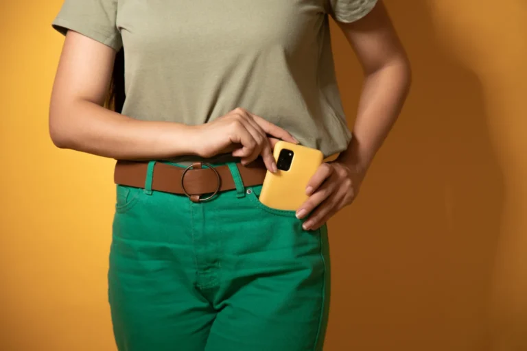 A woman putting her phone away in her pocket